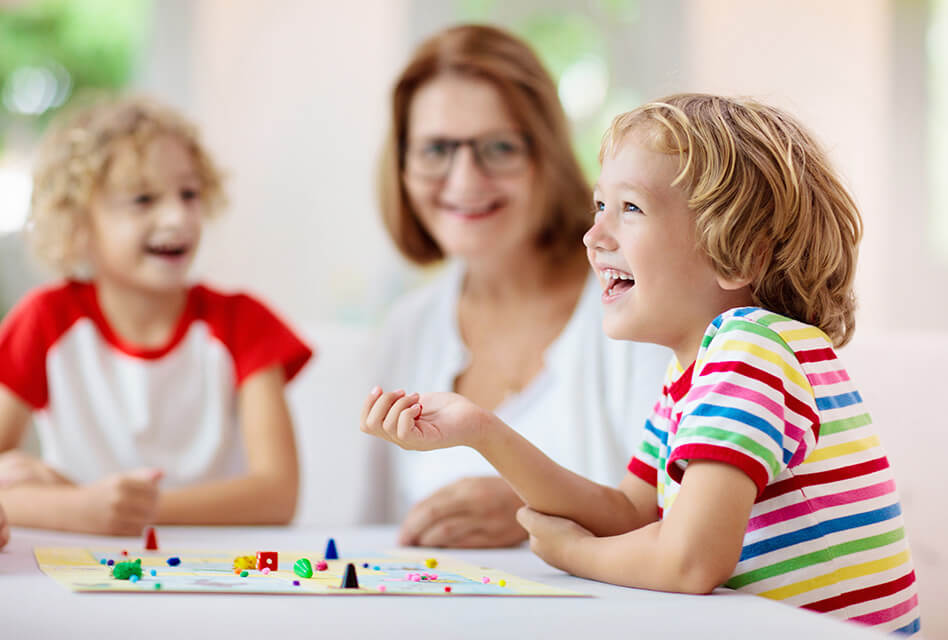 Nanny playing boardgames with kids