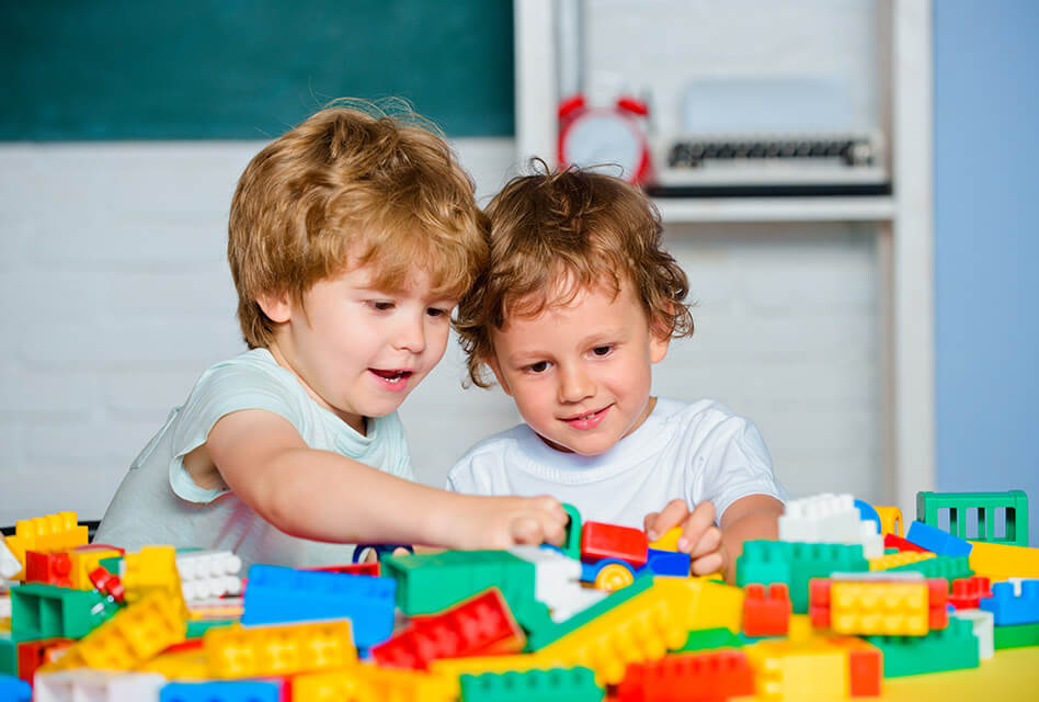 young brothers playing with toy bricks